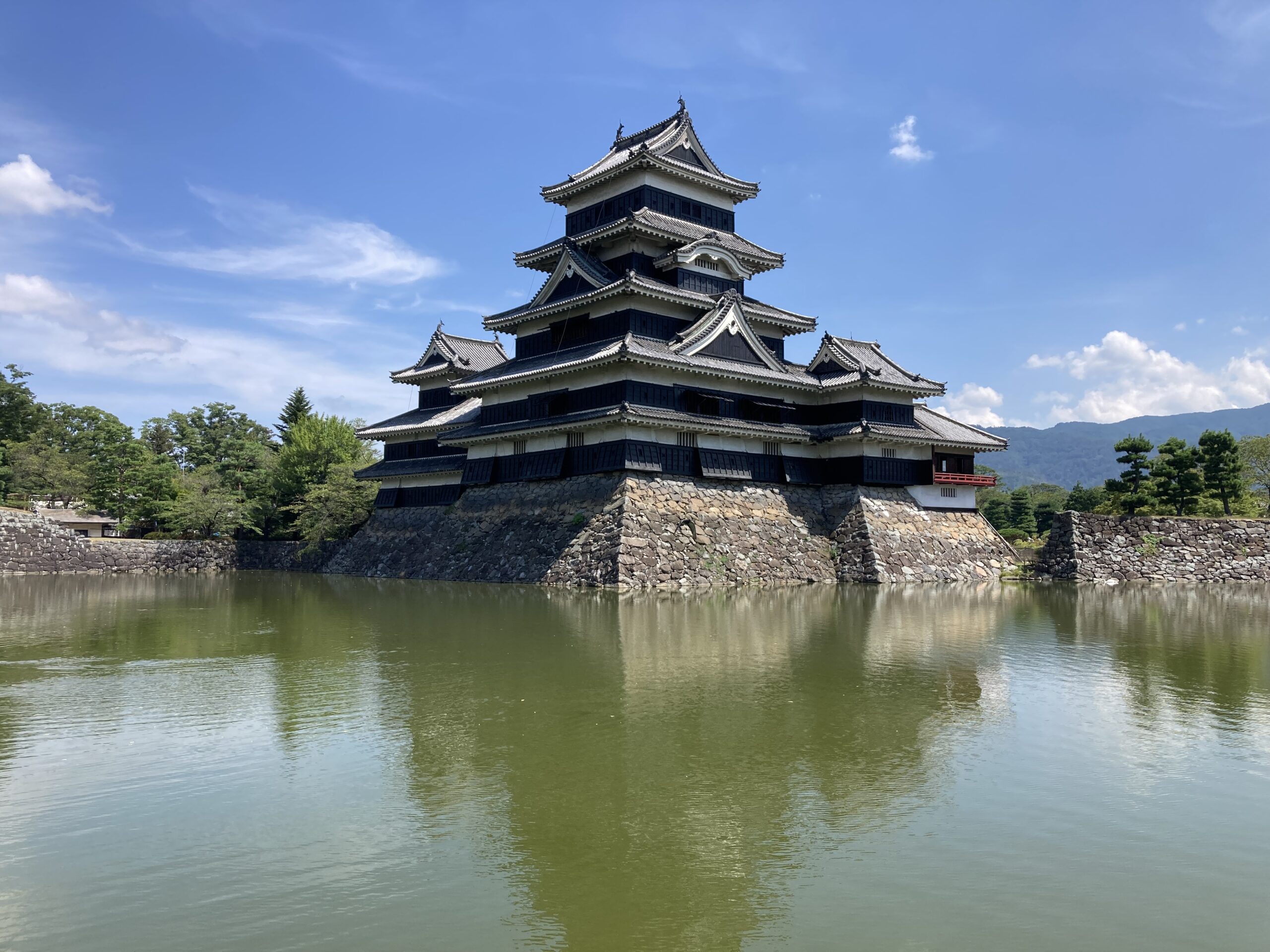 The historic black Matsumoto Castle (Crow Castle) with the snow-capped Northern Alps in the background, Nagano, Japan.